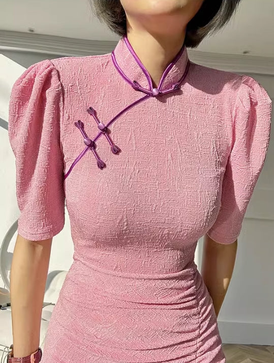 Pink cheongsam. Long skirt with mid-sleeves.