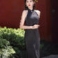 Black sleeveless cheongsam with pearl chain.