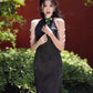 Black sleeveless cheongsam with pearl chain.