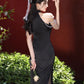 Black sleeveless cheongsam with pearl chain.