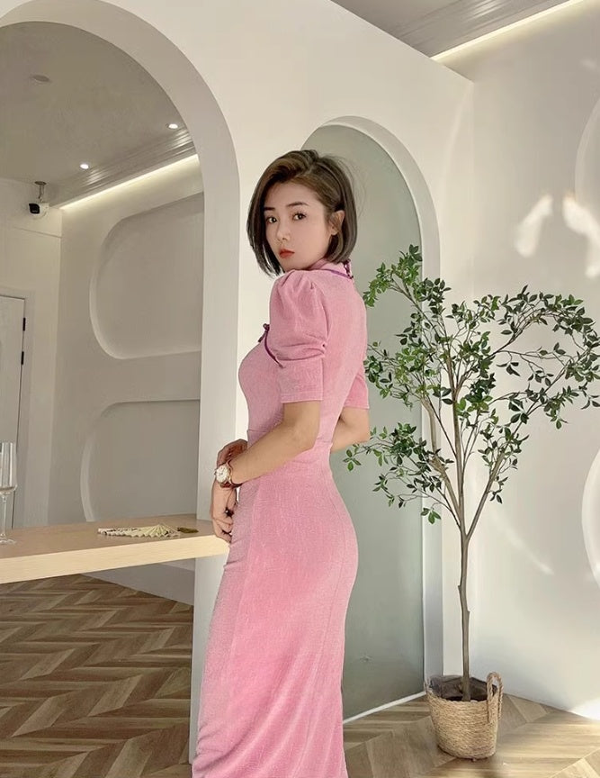 Pink cheongsam. Long skirt with mid-sleeves.