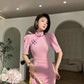 Pink cheongsam. Long skirt with mid-sleeves.