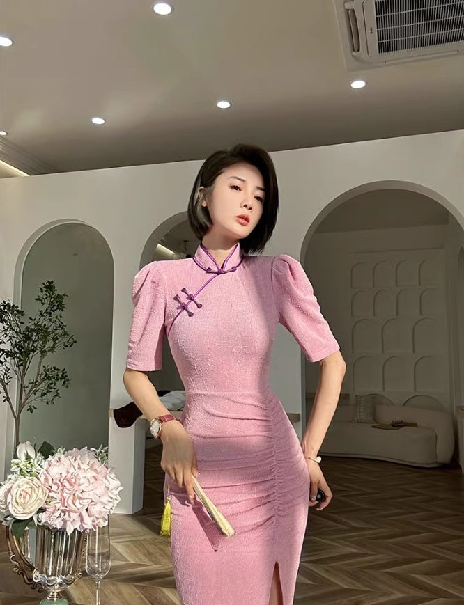 Pink cheongsam. Long skirt with mid-sleeves.