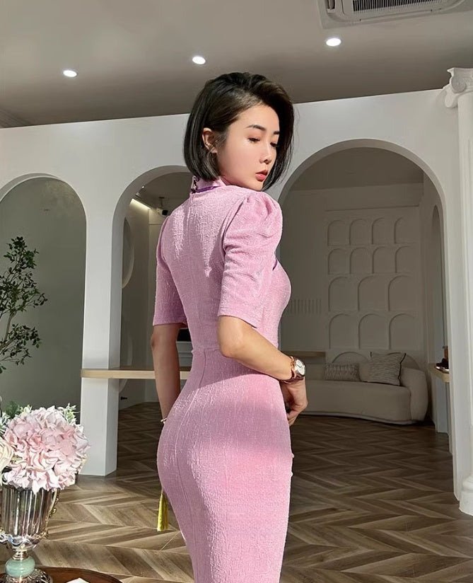 Pink cheongsam. Long skirt with mid-sleeves.