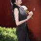 Black sleeveless cheongsam with pearl chain.