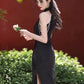 Black sleeveless cheongsam with pearl chain.