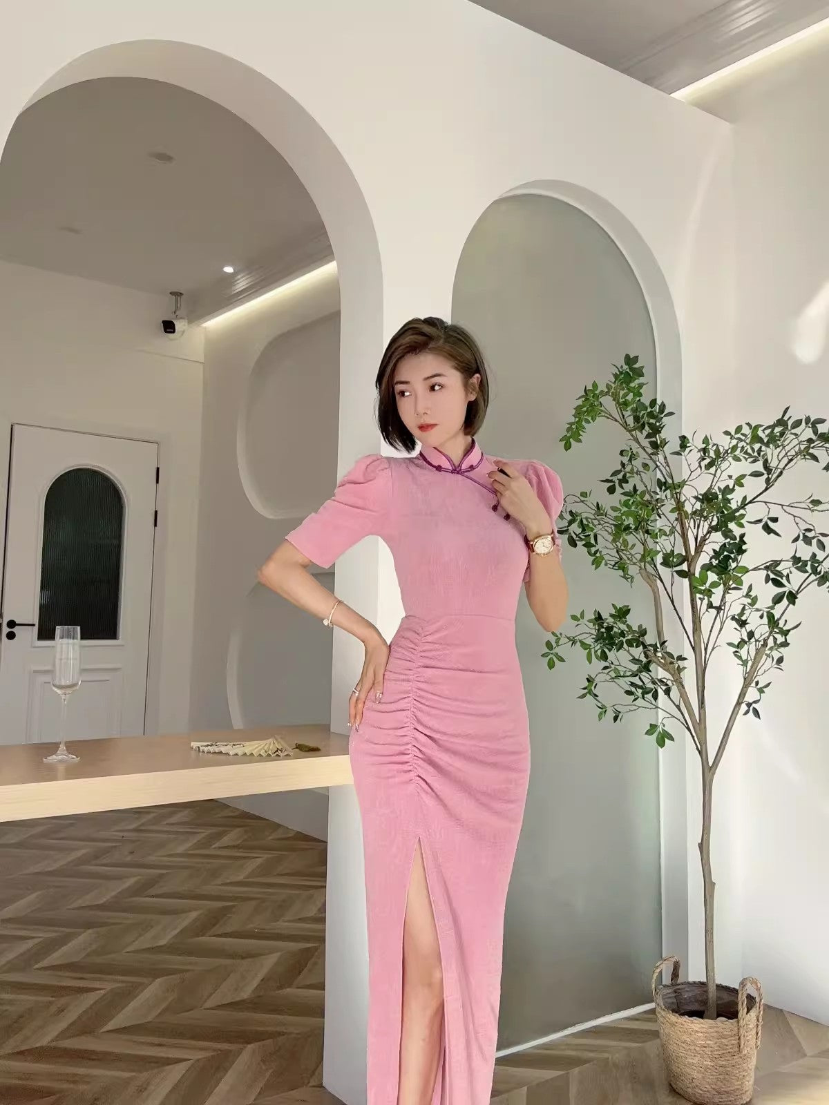 Pink cheongsam. Long skirt with mid-sleeves.