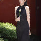 Black sleeveless cheongsam with pearl chain.