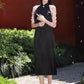 Black sleeveless cheongsam with pearl chain.