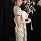 Polka dot cheongsam. Champagne color short-sleeved cheongsam.