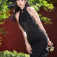 Black sleeveless cheongsam with pearl chain.