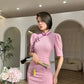 Pink cheongsam. Long skirt with mid-sleeves.