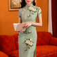 Green jacquard cheongsam. Knee qipao. Silk and polyester blend.