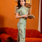 Green jacquard cheongsam. Knee qipao. Silk and polyester blend.