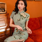 Green jacquard cheongsam. Knee qipao. Silk and polyester blend.